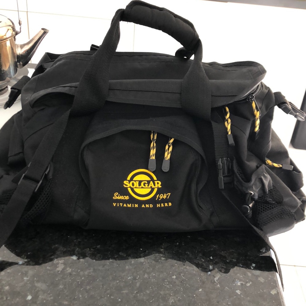 Black canvas duffel gym bag with Solgar logo